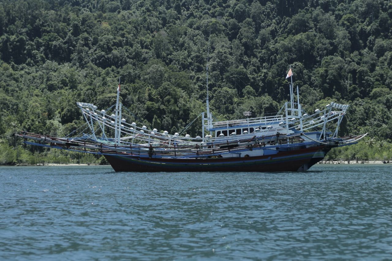 BOATS MOORED ON RIVER