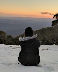Rear view of man looking at sunset