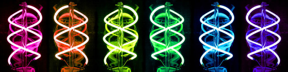 Close-up of illuminated lighting equipment against black background