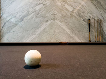 Close-up of ball on table against wall