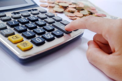 Close-up of person using mobile phone on table