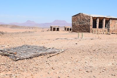 Abandoned house on field against clear sky