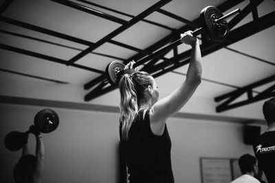 Midsection of woman with arms raised