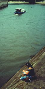 Man sitting on boat in sea