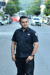 Portrait of man standing on street