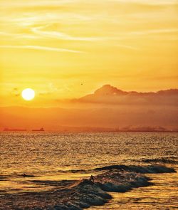 Scenic view of sea against orange sky