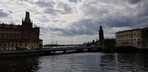 Bridge over river against buildings in city