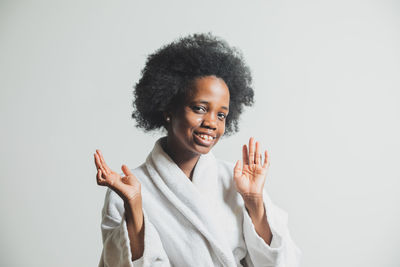 Portrait of young woman against white background