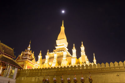 Low angle view of illuminated building against sky at night