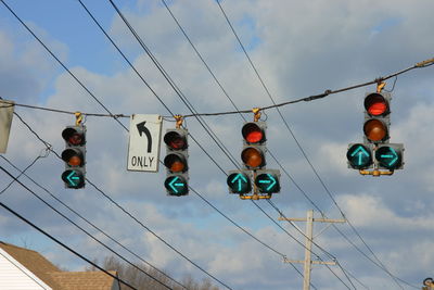 Low angle view of traffic signal against sky