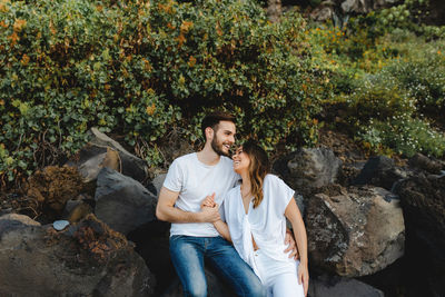 Young couple sitting on rock