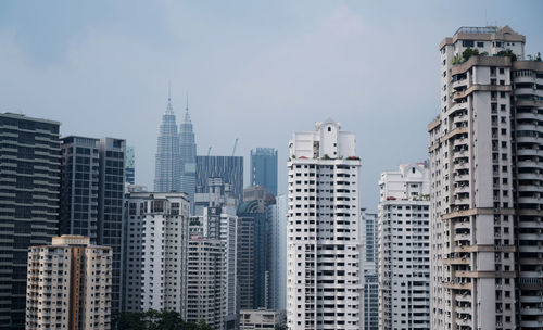 Buildings in city against sky