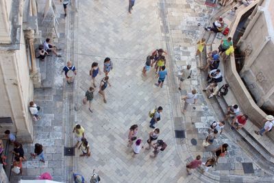 High angle view of people walking on tiled floor