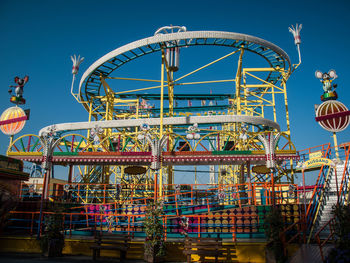 Low angle view of ferris wheel against clear sky