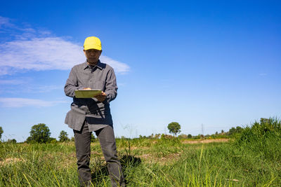 Man standing on field against sky