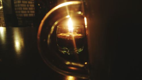 Close-up of illuminated lamp on table