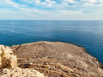 Horizon inland view from the mountain to the ocen with visible sea currents under blue clouded sky