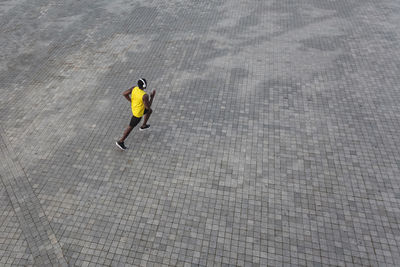 High angle view of man walking on street