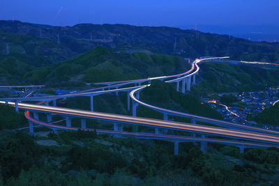 High angle view of light trails on road against sky