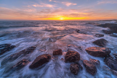 Scenic view of sea against sky during sunset