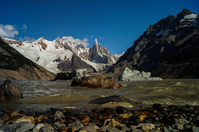 Scenic view of mountains against blue sky