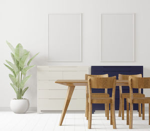 Empty chairs and table against wall at home