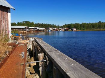 Scenic view of river by building against sky