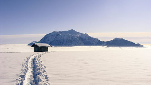 Scenic view of snowcapped mountains against clear sky