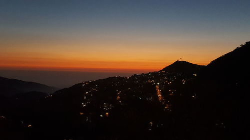 Scenic view of silhouette mountain against sky during sunset