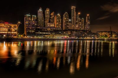 Illuminated city buildings at night