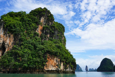 Rock formations by sea against sky