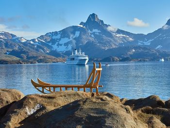 Scenic view of lake by mountains against sky