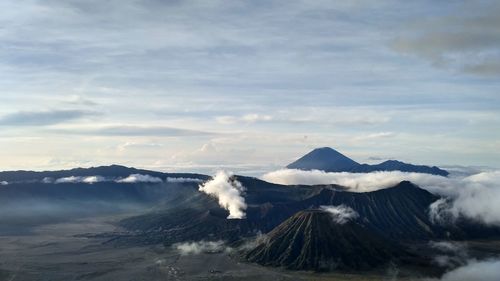 Scenic view of mountains against cloudy sky