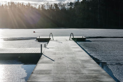 Pier over lake against sky