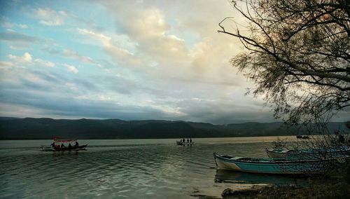 Scenic view of lake against cloudy sky