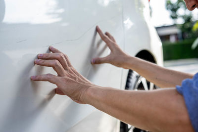 Close-up of man hand holding car