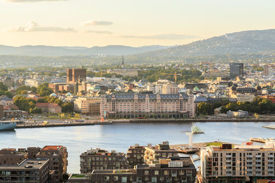 High angle view of river and buildings in city