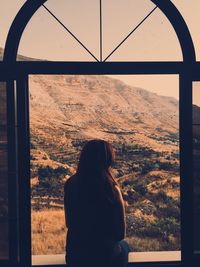 Rear view of woman against sky