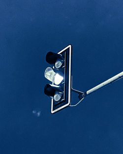 Low angle view of road signal against blue sky