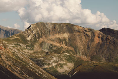 Scenic view of mountains against cloudy sky