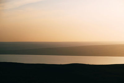 Scenic view of silhouette landscape against sky during sunset