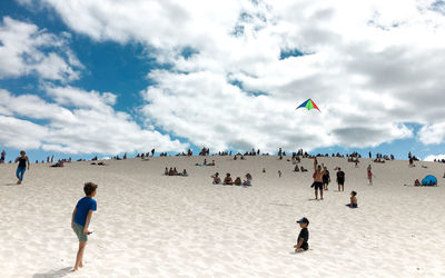 Rear view of people enjoying at sea