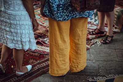 Low section of people standing on street