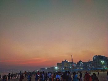 Group of people in city at sunset