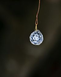 Close-up of decoration hanging against black background