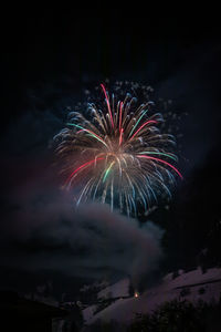 Low angle view of firework display at night