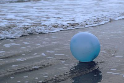 Close-up of balloon on beach