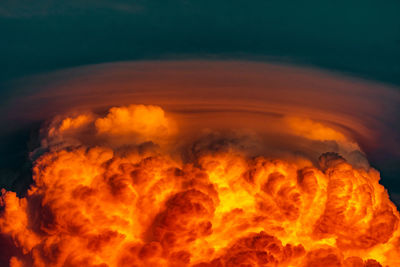 View of fire against clouds at sunset