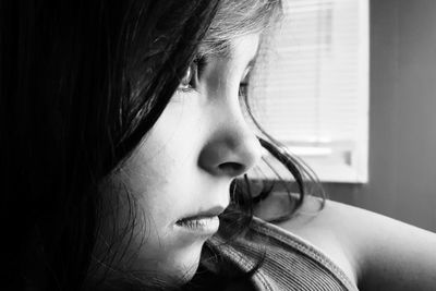 Close-up of thoughtful girl looking away at home