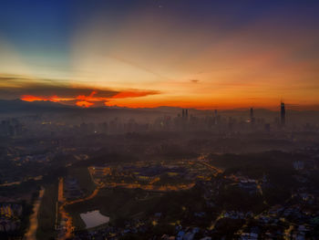 High angle view of buildings against sky during sunset